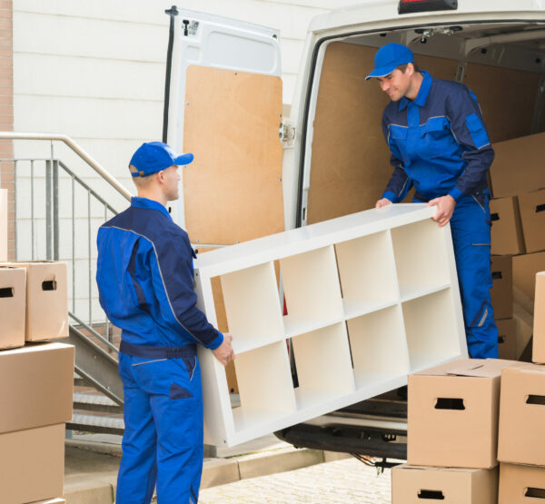 Young,Male,Movers,Unloading,Furniture,And,Cardboard,Boxes,From,Truck